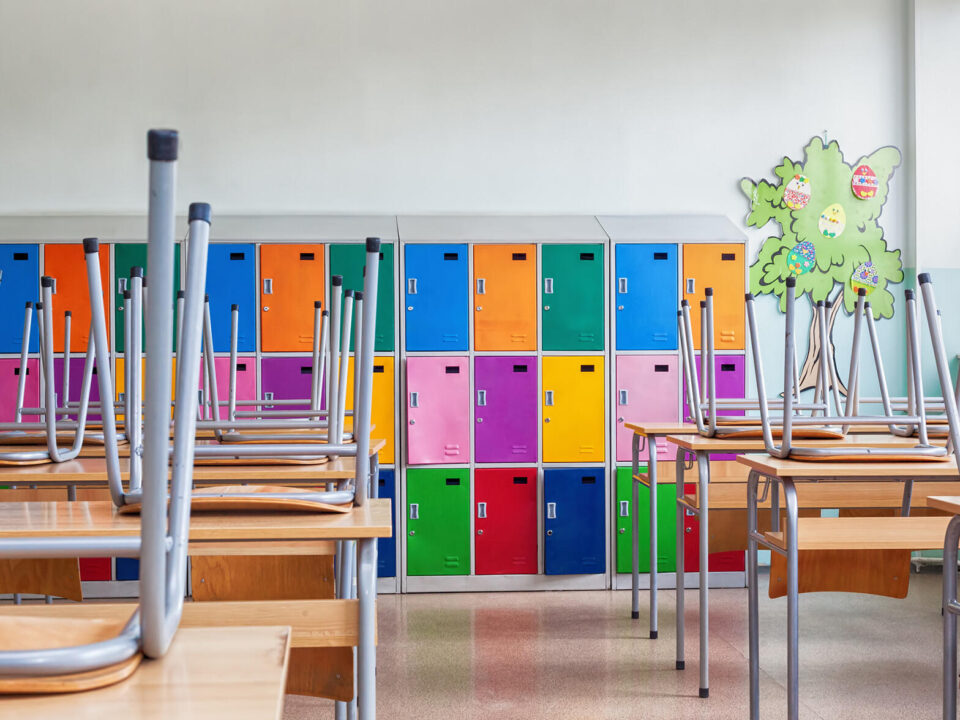 Classroom with colorful lockers and raised chairs on the tables